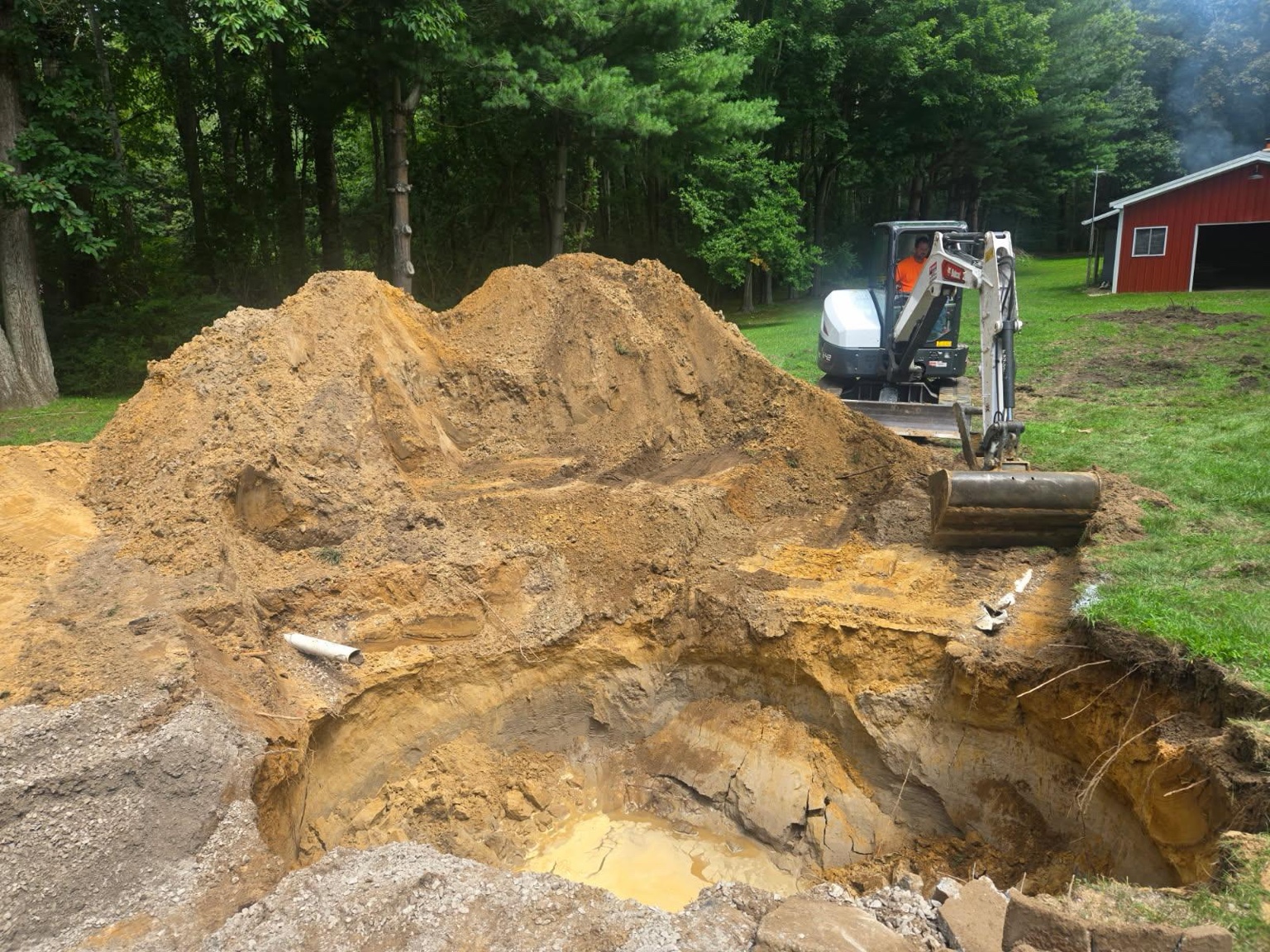Excavator completing residential earthwork